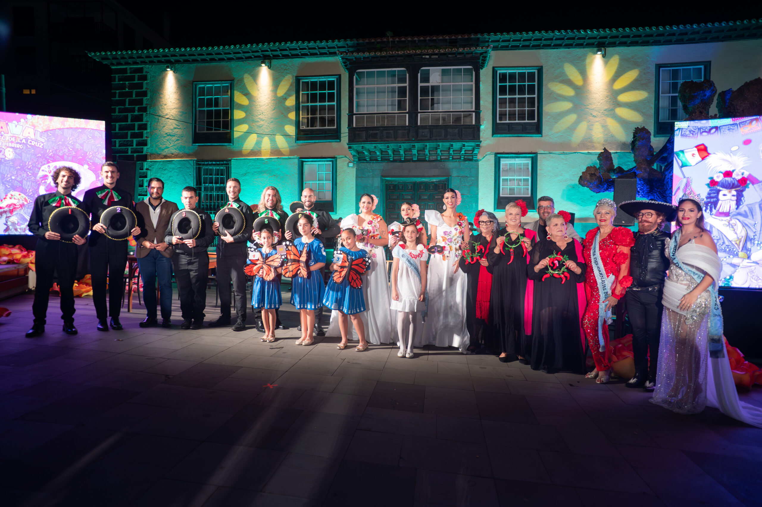 Carnival performers and families together on the opening gala stage in Puerto de la Cruz