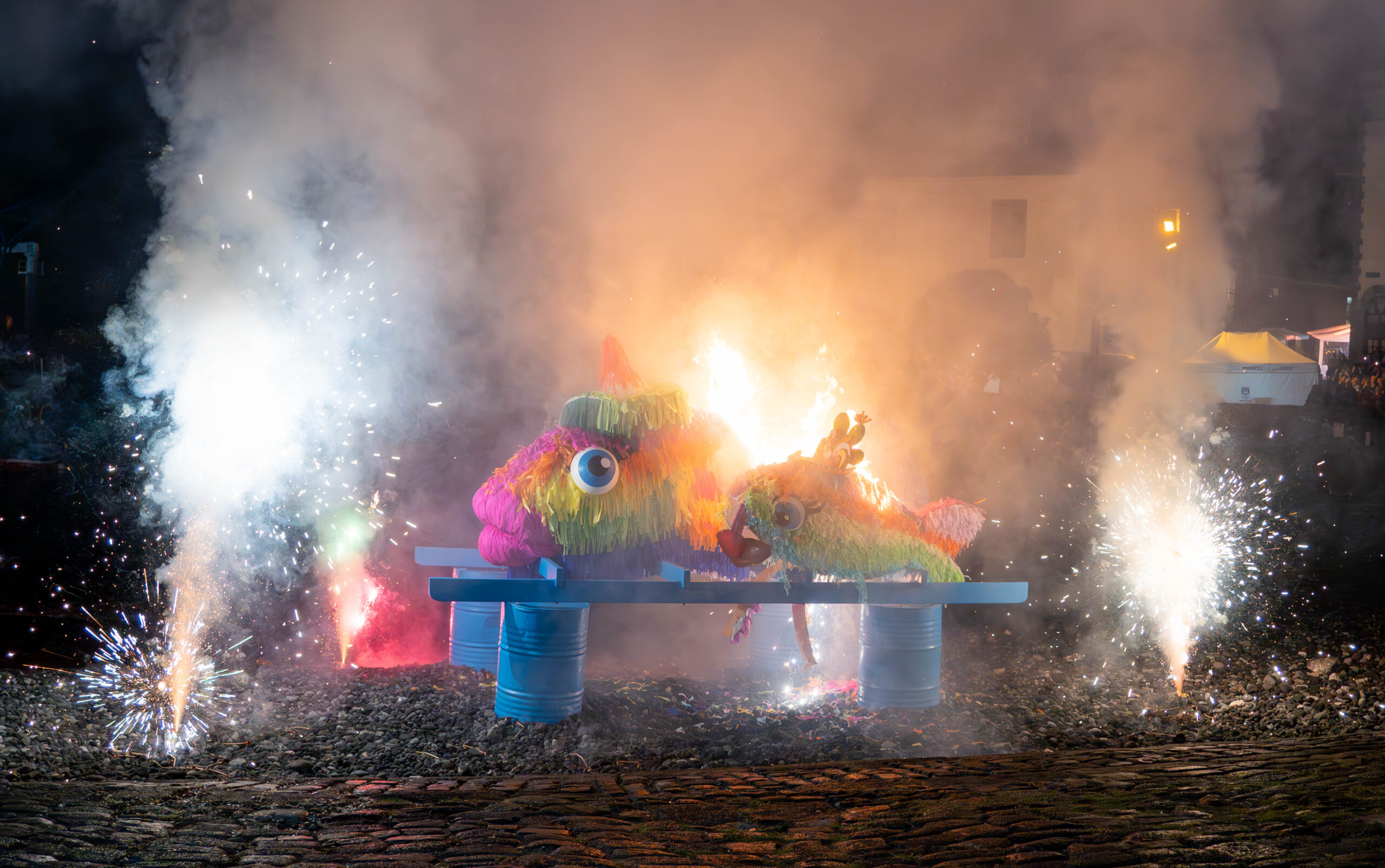 Colourful sardine effigy beside the Puerto de la Cruz fishing harbour at night