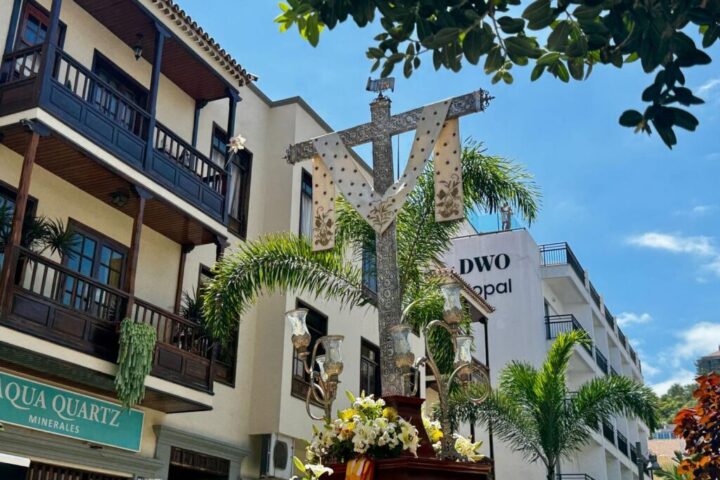 Flower-covered cross carried through a Puerto de la Cruz street on 3 May