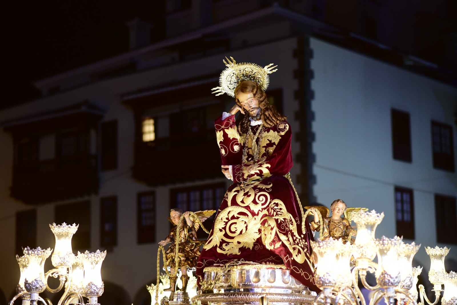 Gran Poder de Dios statue illuminated at night during a Puerto de la Cruz procession