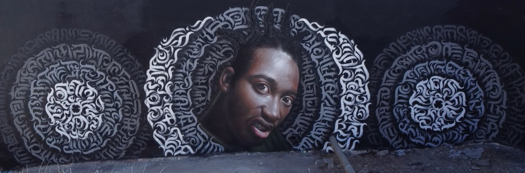 Portrait mural surrounded by white lettering, pictured in the October 2024 street-art update