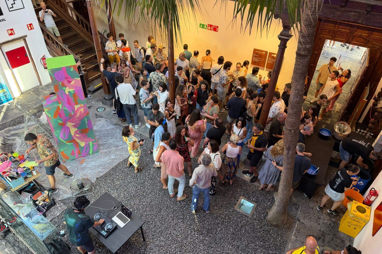 Visitors gather beside a colourful painting at the 2026 Phe Gallery opening inside Casa de la Aduana