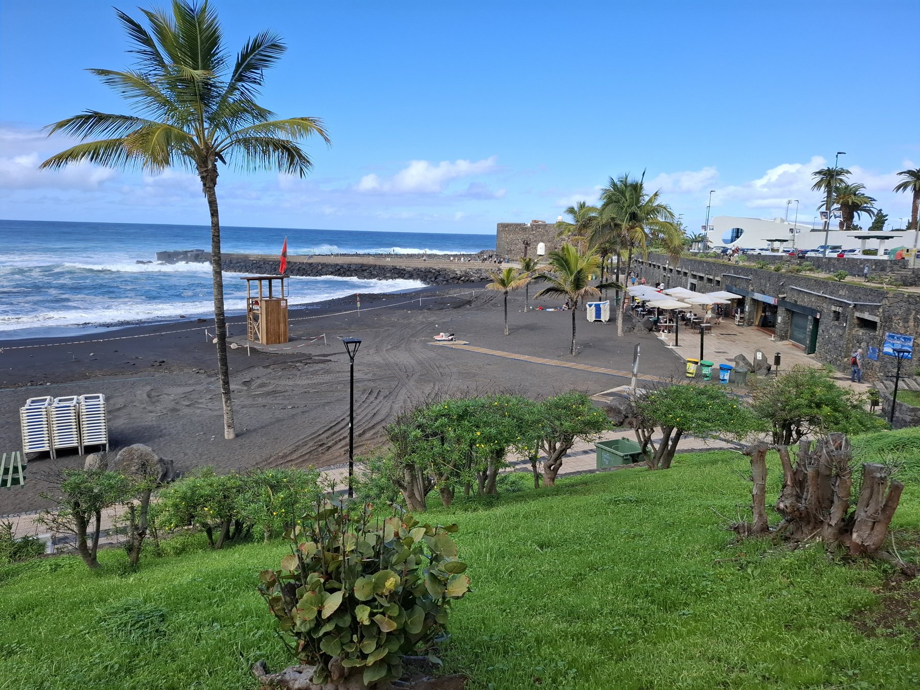 Playa Jardín seafront with Castillo San Felipe in Puerto de la Cruz; venue surroundings photographed in 2025