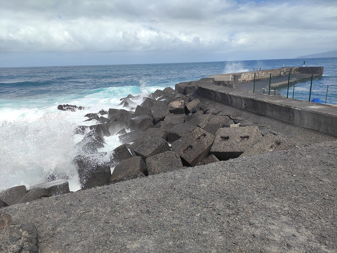Atlantic waves beside the Puerto de la Cruz harbour breakwater outside festival time in 2024