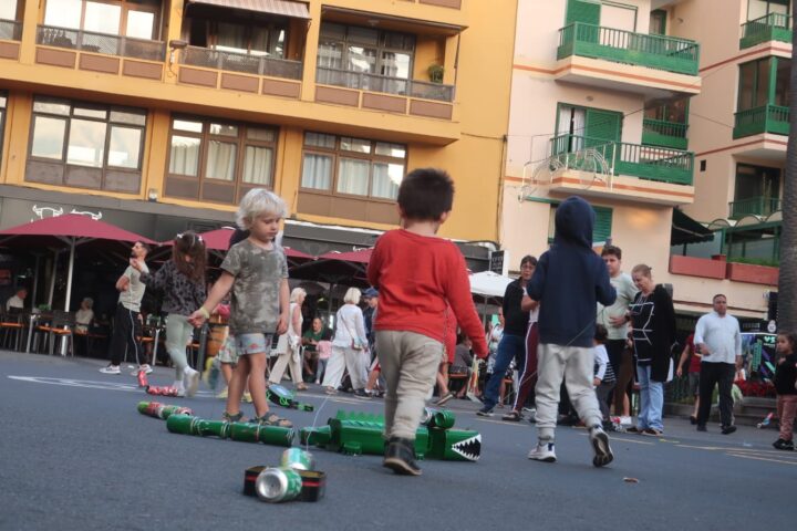 Children pulling homemade tin-can cacharros across Plaza del Charco in Puerto de la Cruz during San Andrés
