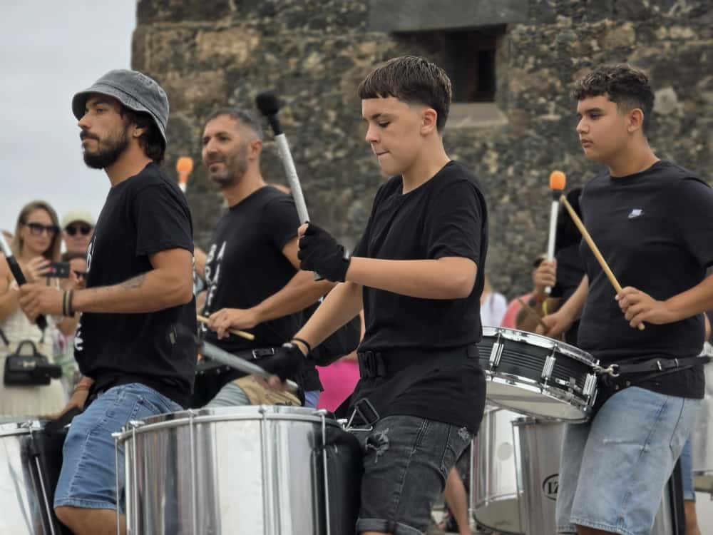 Members of a Summer Carnival percussion group playing large drums in Puerto de la Cruz in 2025
