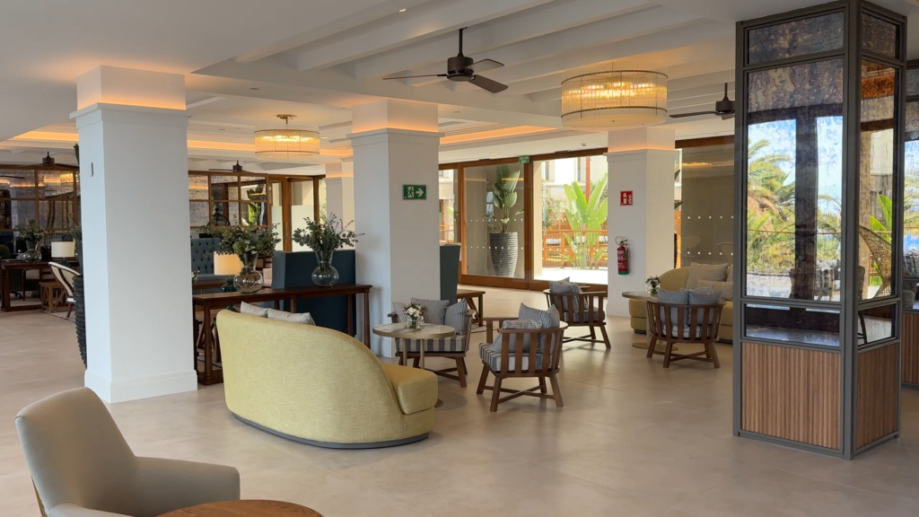 Lounge seating, white columns and tall windows inside Gran Hotel Taoro