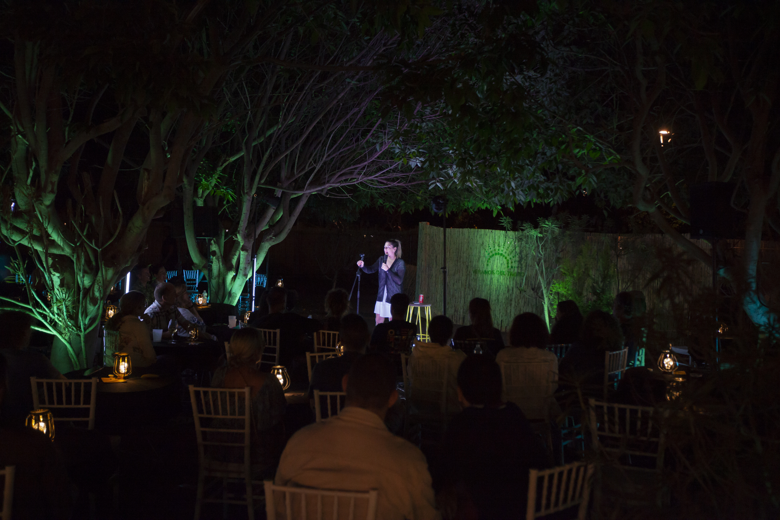 Audience seated among trees for cabaret at Veranos del Taoro